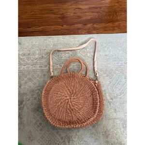 Clare V Woven Round Crossbody Bag in Natural Tan.